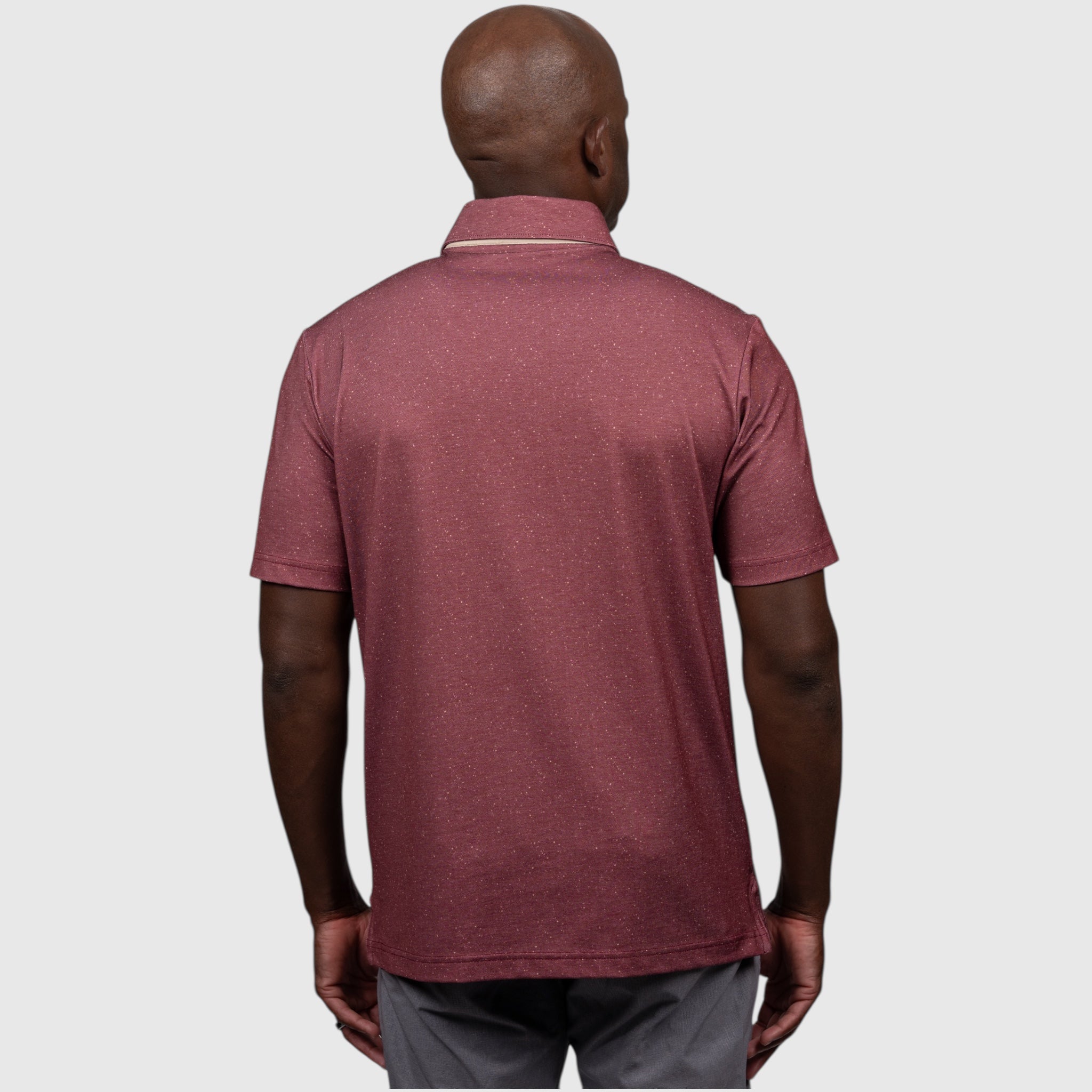 Man wearing a garnet FSU polo shirt on a white background