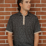 UCF Knights Fairway Floral four-button polo in black and gold floral pattern