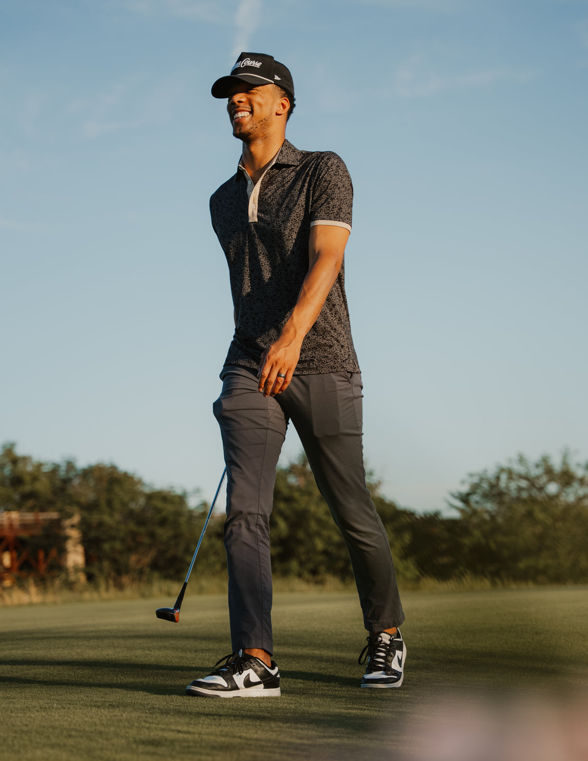 UCF Knights Fairway Floral four-button polo in black and gold floral pattern