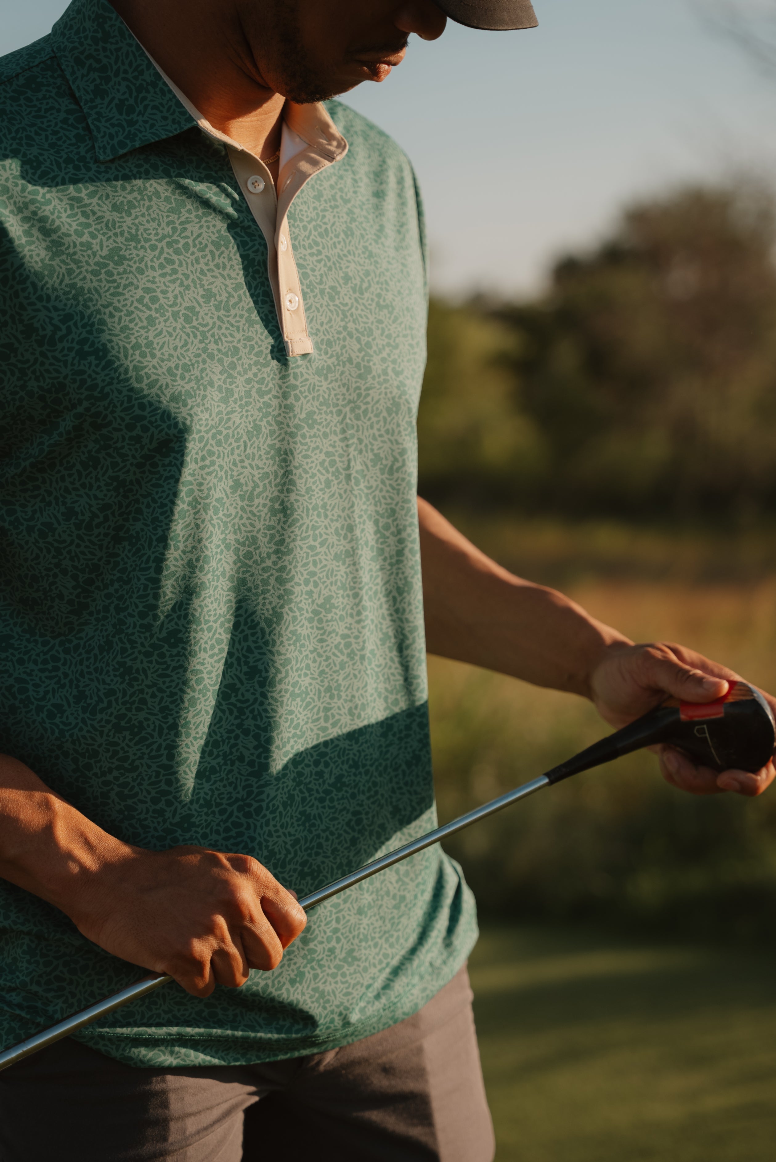 USF Bulls Fairway Floral four-button polo in green and gold floral pattern