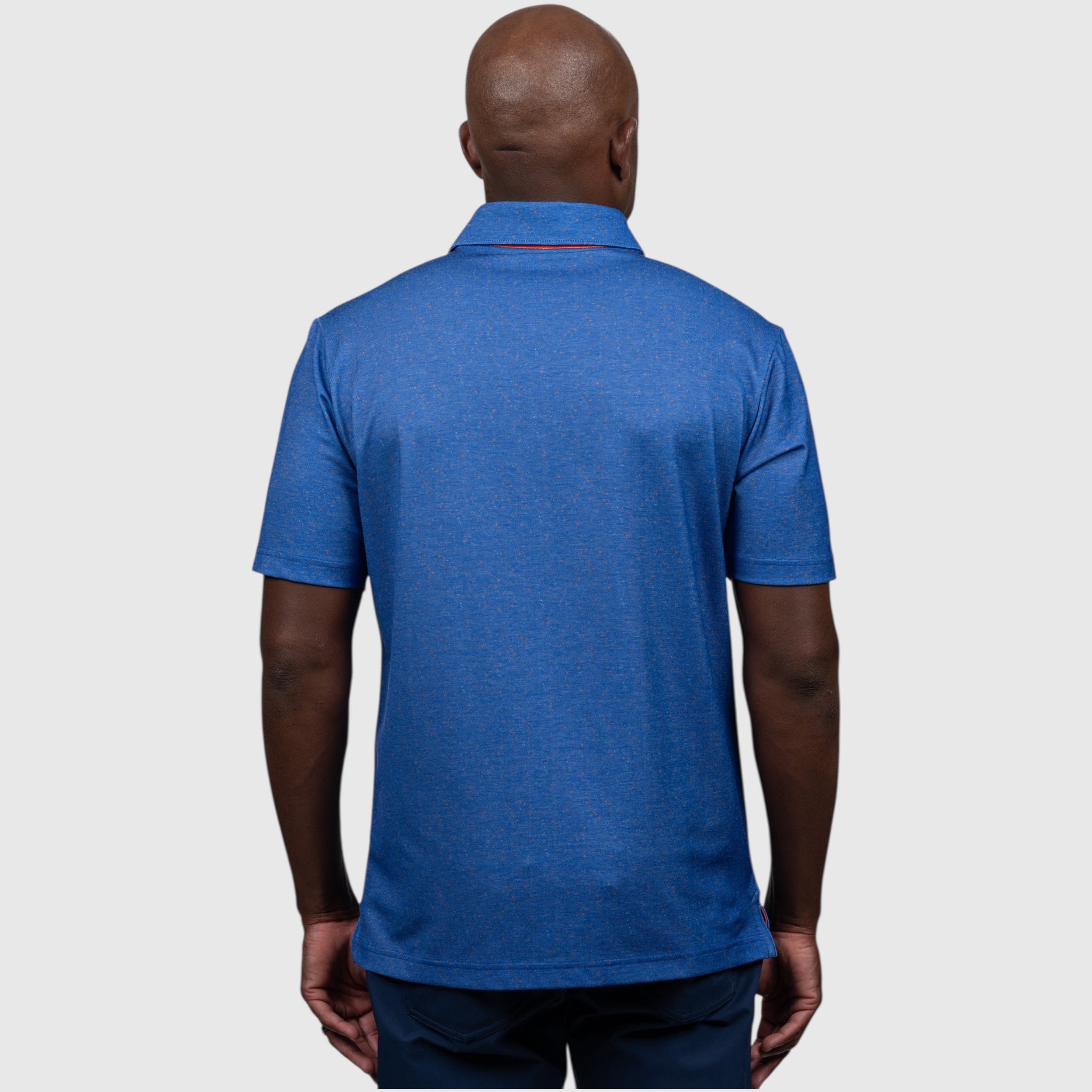 Person wearing a blue UF polo shirt on a white background