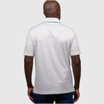 Man wearing a white UF polo shirt with a subtle pattern on a white background